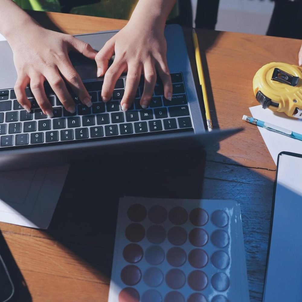 a-person-working-on-a-laptop-with-construction-plans-free-photo